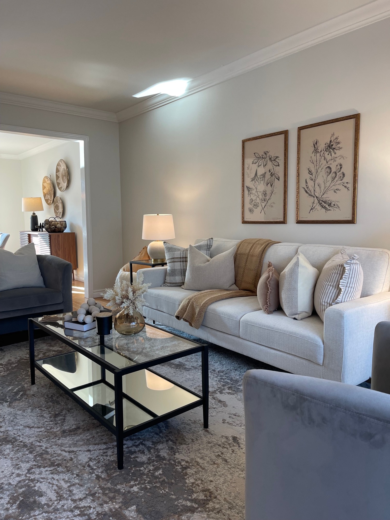 Same living room after staging, styled with warm, inviting furnishings